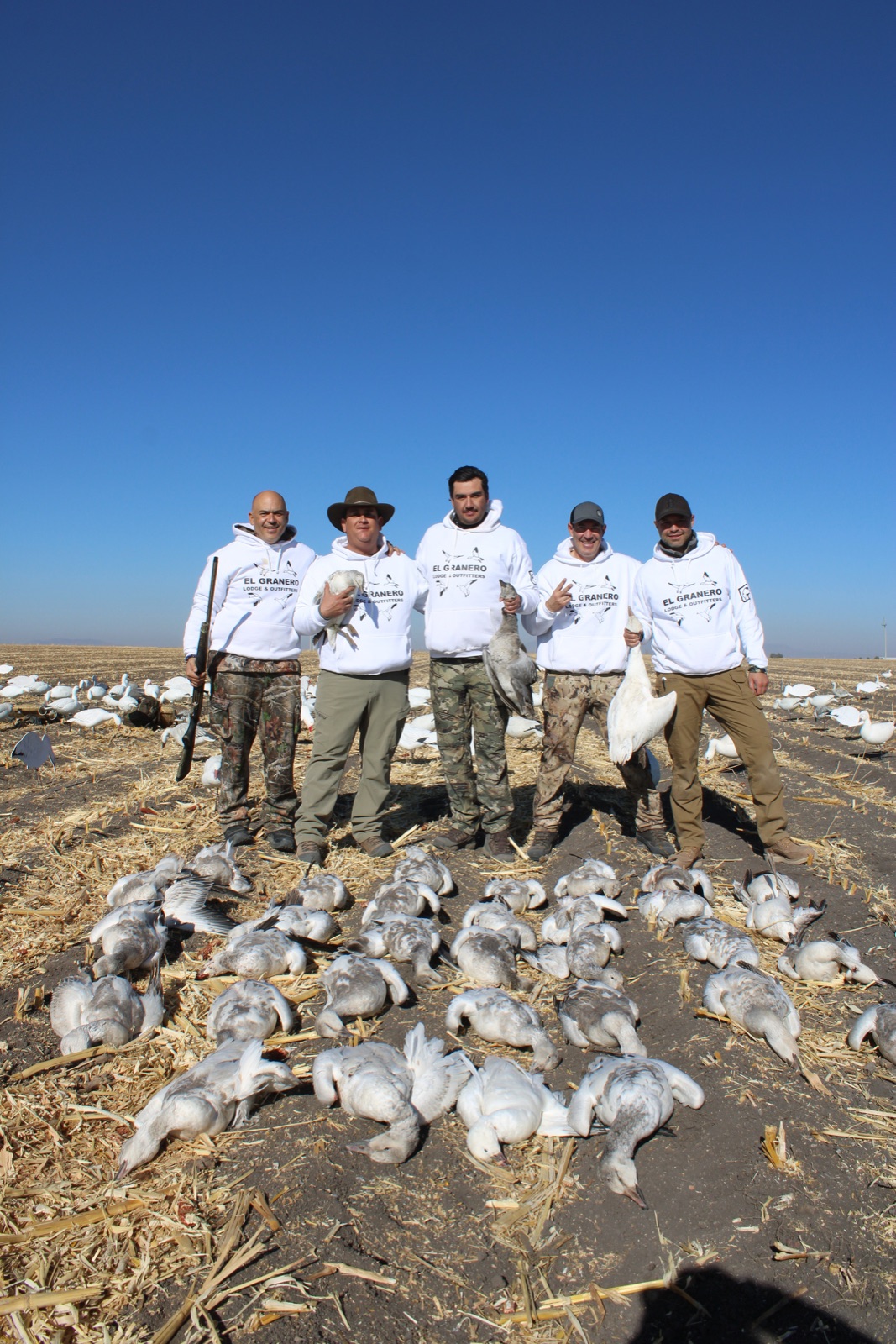 Five El Granero guides in branded white hoodies with snow geese